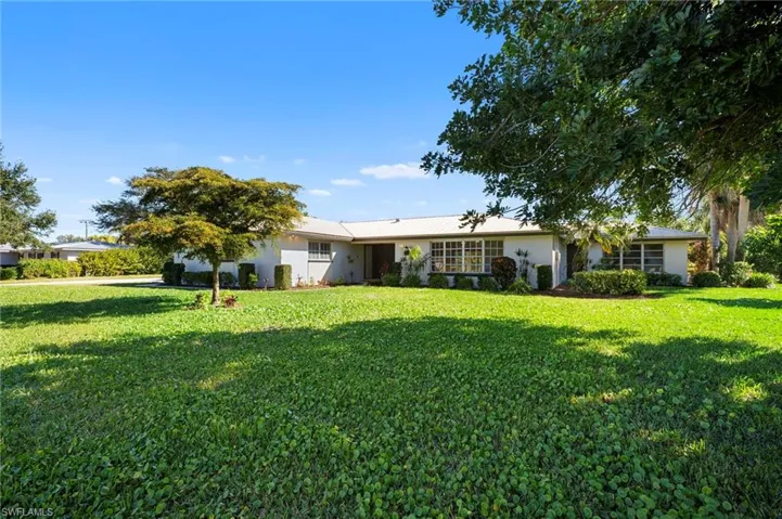 Single story home featuring a front lawn and stucco siding