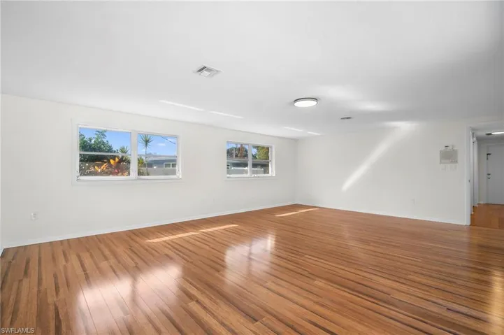 Unfurnished room with hardwood / wood-style floors and baseboards