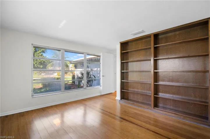 Unfurnished living room featuring light wood-style flooring and baseboards