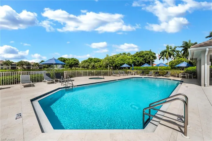 View of community pool & spa featuring a clubhouse with fitness nd community room