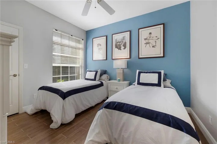 Bedroom featuring wood-type flooring and ceiling fan