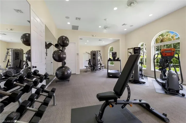 Exercise room featuring light colored carpet