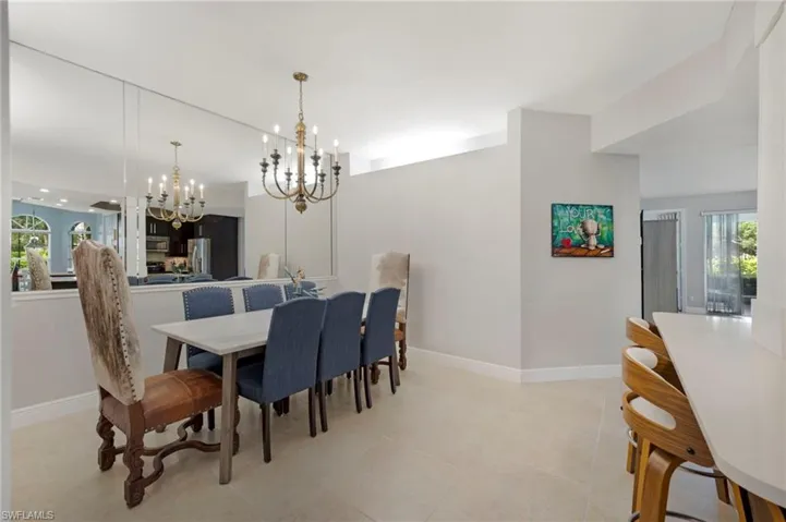 Tiled formal dining space featuring plenty of natural light and an inviting chandelier
