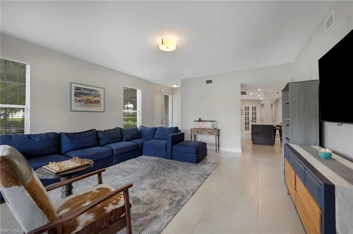 Living room featuring  natural light and light tile flooring