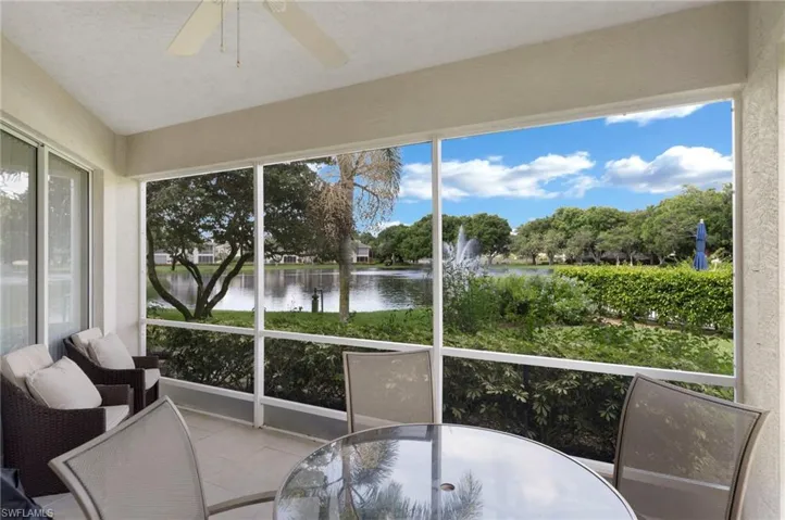 Sunroom with a water view and ceiling fan