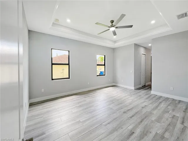 Spare room with a ceiling fan, light wood-style flooring, and recessed lighting