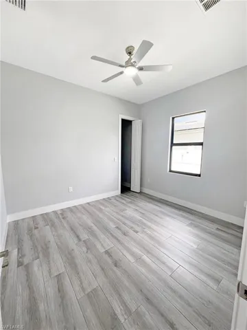 Unfurnished bedroom featuring a ceiling fan and light wood finished floors