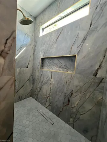 Bathroom view of a marble finish shower