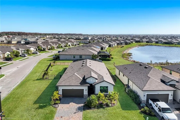 Aerial perspective of suburban area featuring a nearby body of water