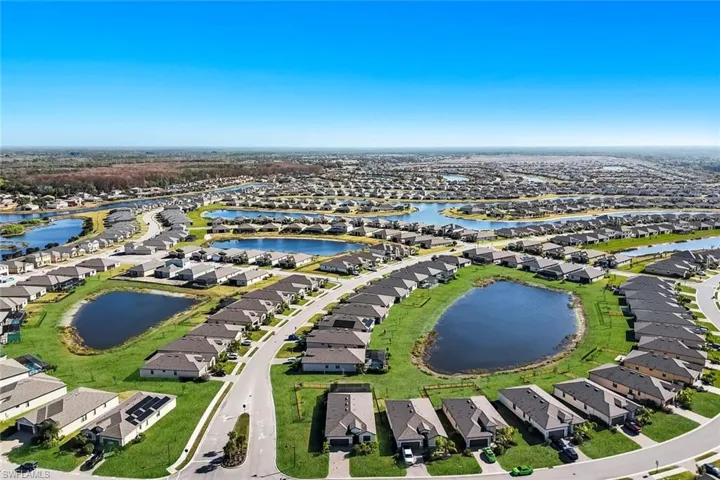 Aerial perspective of suburban area featuring a large body of water