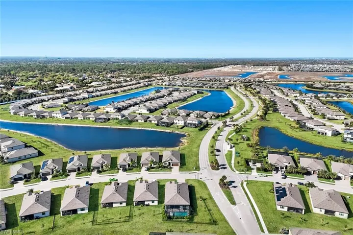 Aerial view of residential area featuring a nearby body of water
