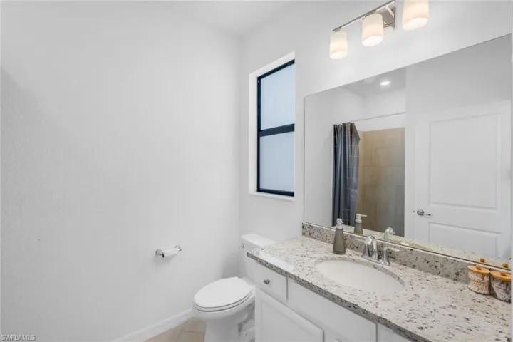 Full bath with vanity and curtained shower