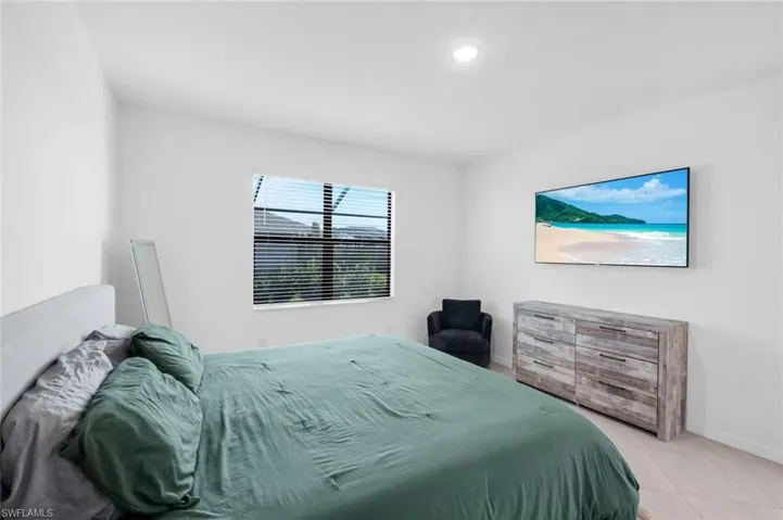Bedroom with baseboards and tile patterned flooring