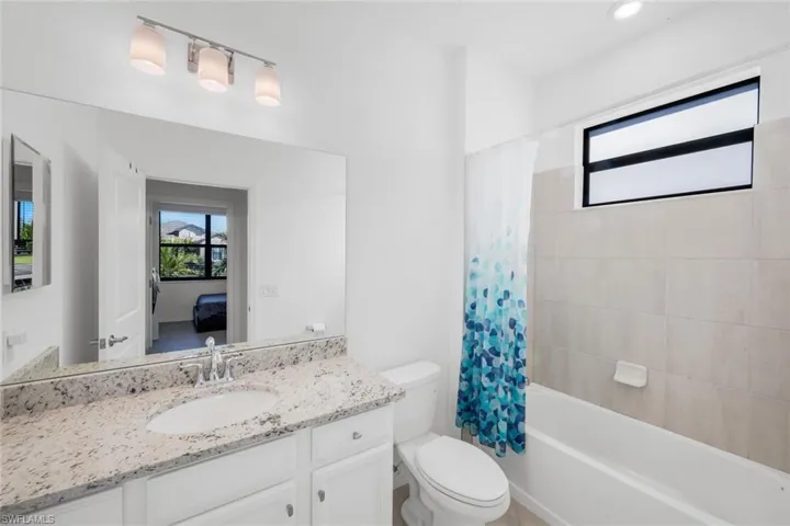 Full bath featuring shower / bath combo with shower curtain and vanity