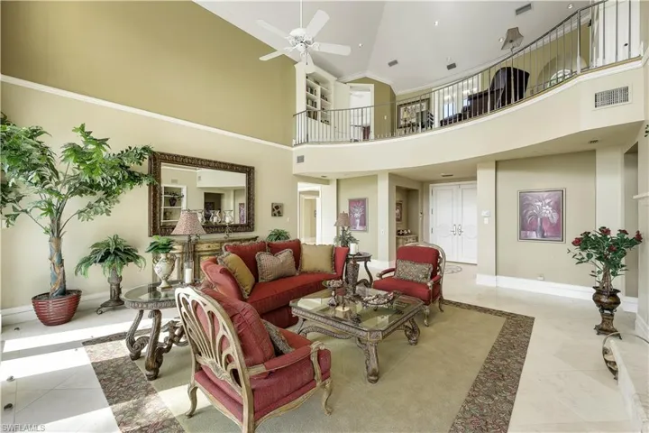 Enter the formal yet comfortable living room through the entry foyer.  The living room offers direct views of the river, a working fireplace, and vaulted ceilings.