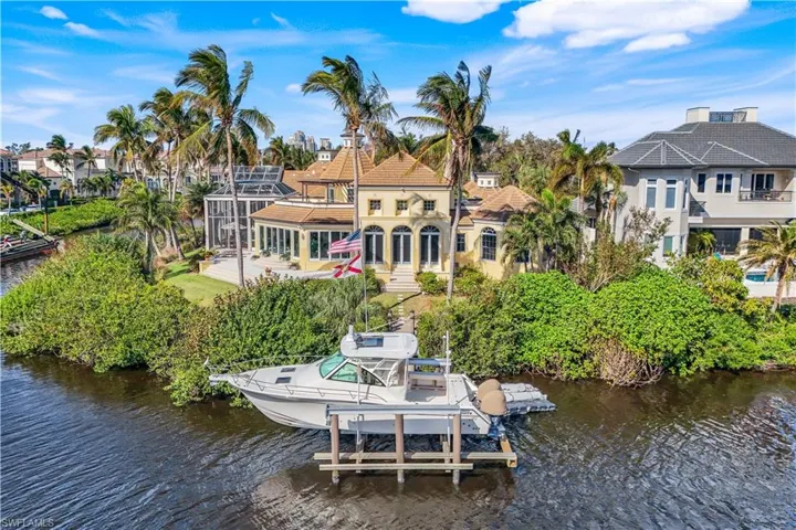 Prepare to be captivated by this majestic gulf access Bonita Bay riverfront home surrounded by water on the South and West sides!
