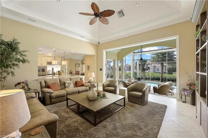 Sliding doors open to an expansive lanai and a beautiful pool area, seamlessly blending indoor and outdoor living.