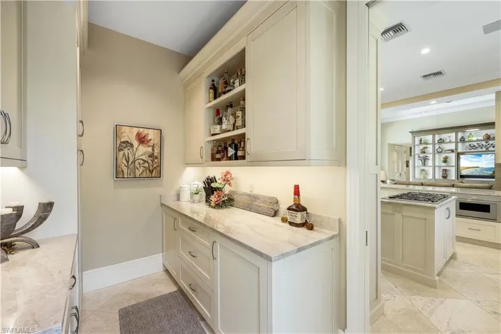 This sleek pantry is conveniently located between the kitchen and the formal dining room.