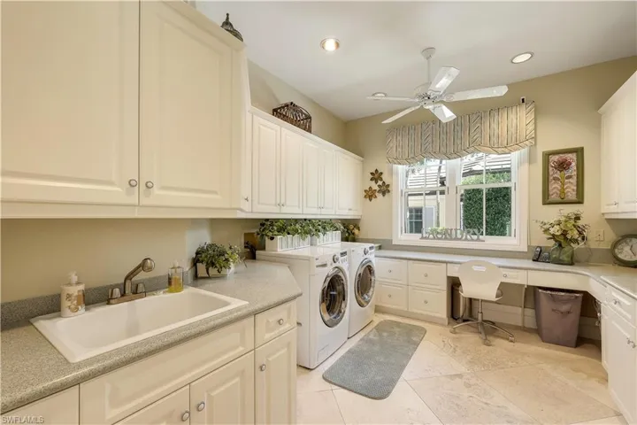 Spacious laundry room with plenty of storage.