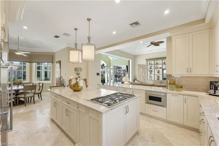 Completely renovated kitchen open to den, covered lanai and breakfast area.  Sliding doors in living room open to the most stunning outdoor space.