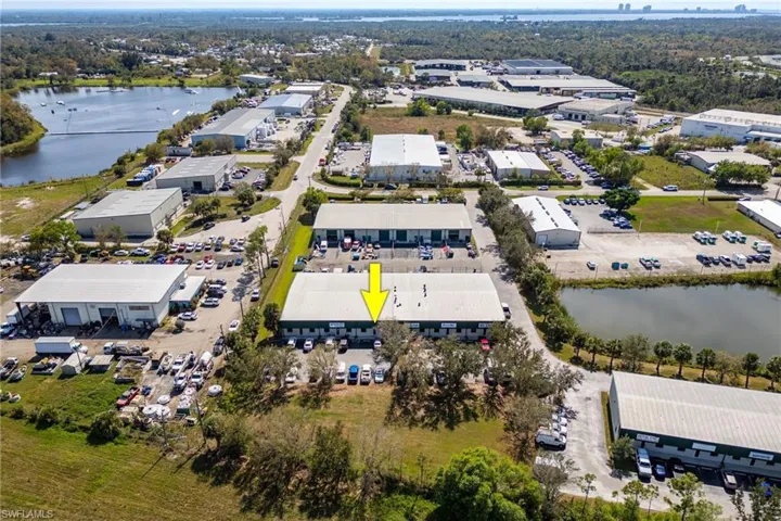 Birds eye view of property with a water view