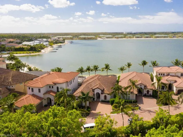 Birds eye view of property with a water view