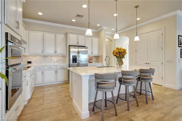 cooks kitchen with huge island, stainless appliances & breakfast bar