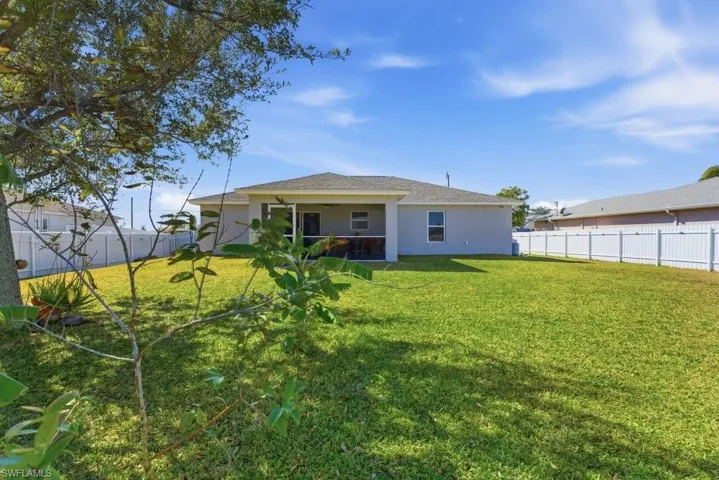 Rear view of property featuring a fenced backyard, stucco siding, and a patio