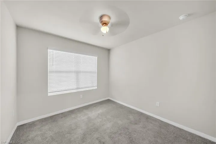 Unfurnished room with carpet and ceiling fan