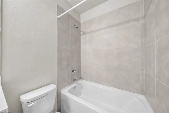 Bathroom with shower / bathtub combination and toilet
