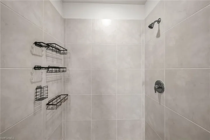 Bathroom view of a tile shower