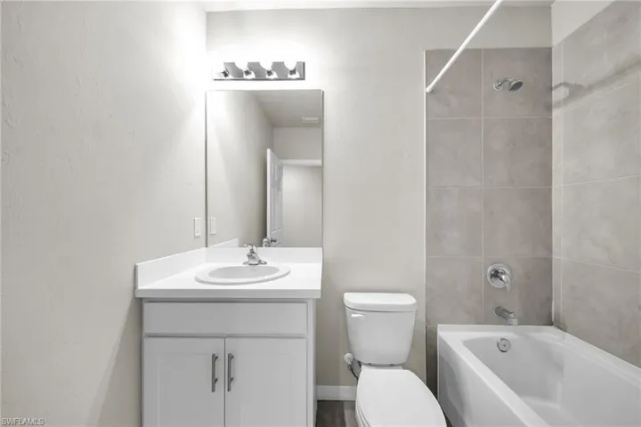 Full bathroom with shower / tub combination and vanity