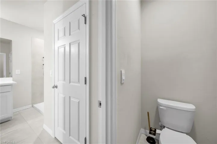 Full bath featuring vanity, a shower stall, and light tile patterned floors