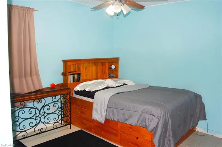 Tiled bedroom with ceiling fan
