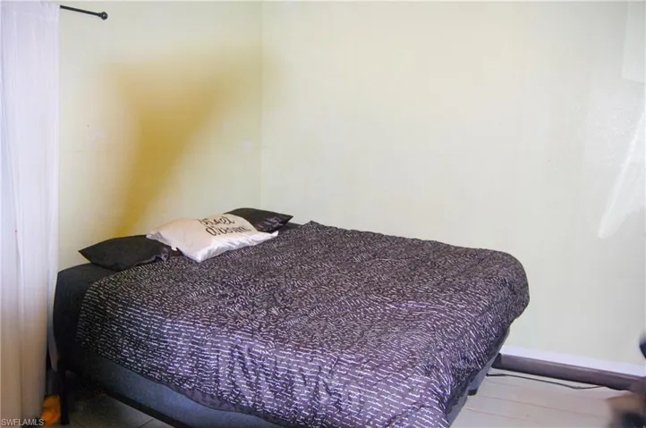 Bedroom with hardwood / wood-style flooring
