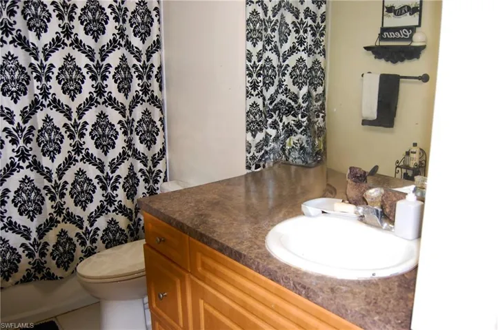 Bathroom with tile patterned floors, vanity, and toilet