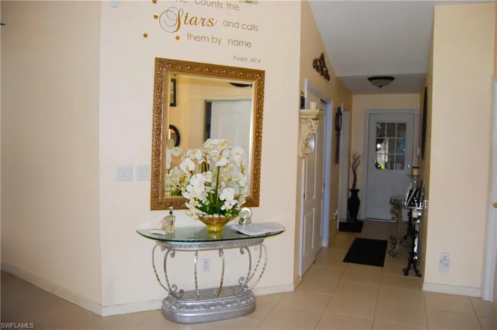 Hallway featuring light tile patterned floors