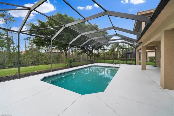 View of swimming pool with a patio, a yard, and a lanai