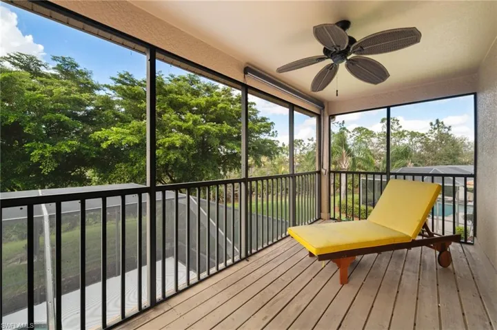 Unfurnished sunroom with ceiling fan