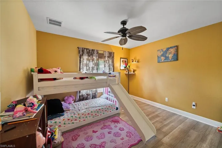 Bedroom with hardwood / wood-style floors and ceiling fan