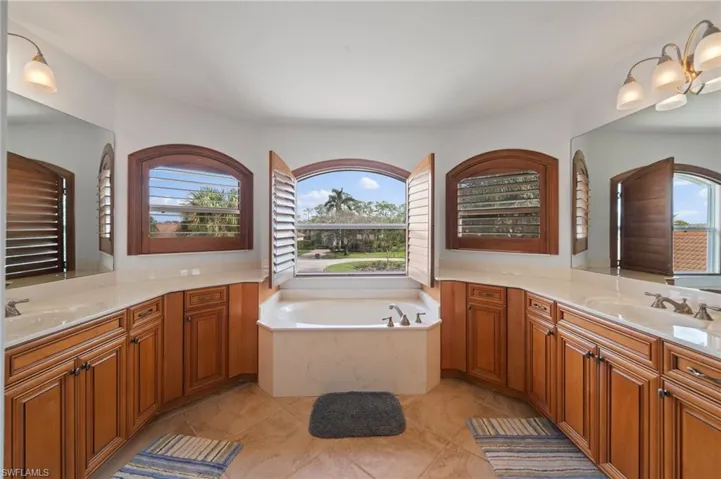 Bathroom with vanity, tile patterned floors, and a bathing tub