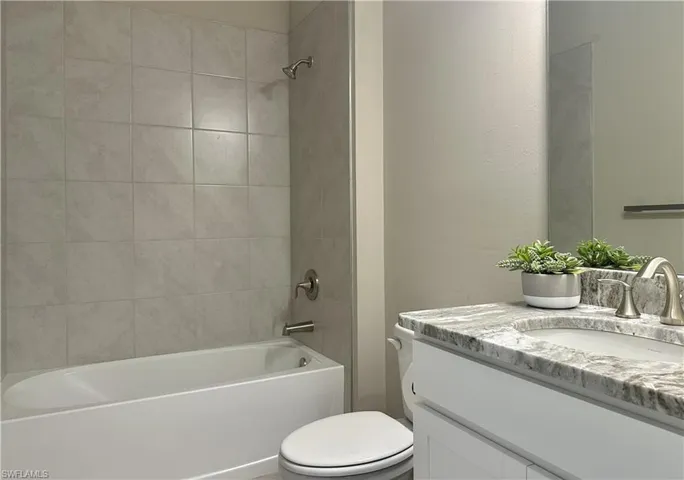 Bathroom featuring vanity and tub / shower combination