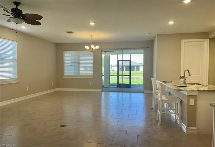 Dining area with recessed lighting, ceiling fan, a chandelier, and light tile patterned floors
