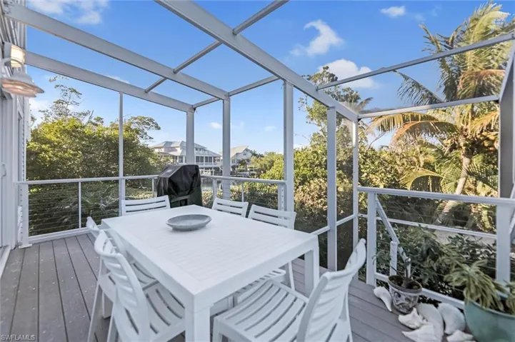 Sunroom / solarium featuring outdoor dining space, a wooden deck, and plenty of natural light