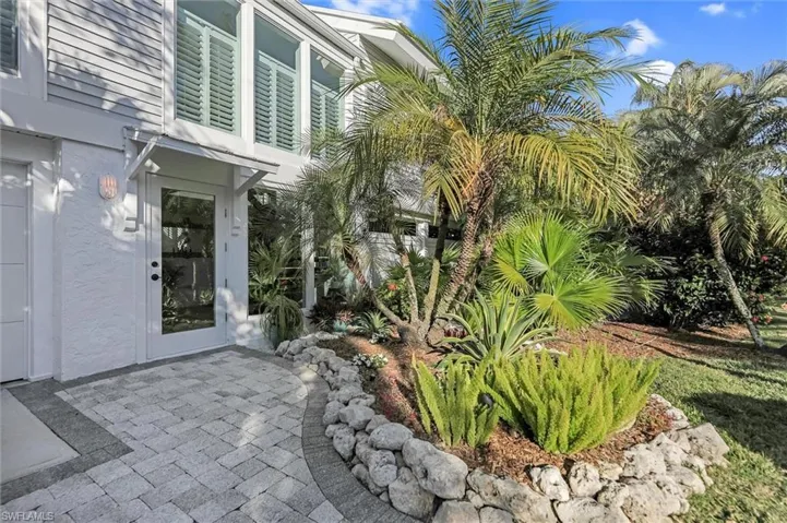 View of exterior entry featuring a patio and stucco siding