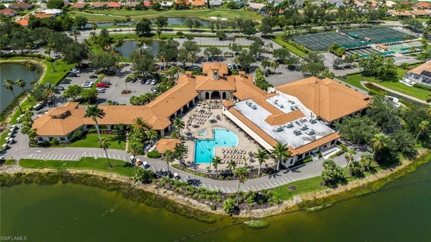 Expansive multi-building complex featuring a central swimming pool, surrounding lounge areas, and multiple parking lots