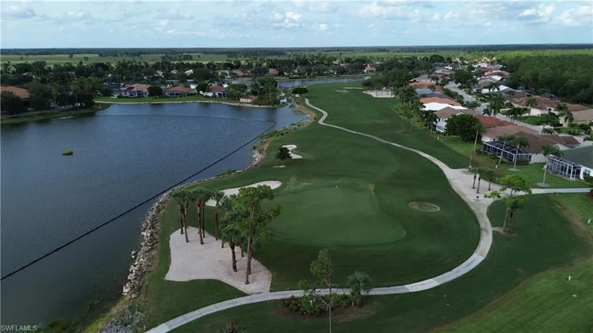 Expansive golf course green with manicured turf and sand traps