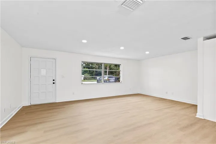 Empty room with light hardwood / wood-style flooring