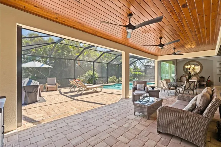 View of patio featuring an outdoor pool, an outdoor living space, ceiling fan, and a lanai
