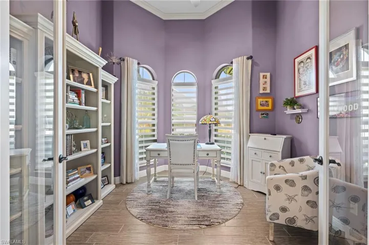 Office featuring french doors, baseboards, crown molding, and wood finish floors